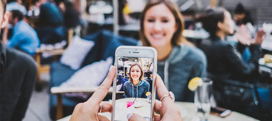 Woman taking a video with her smartphone for a TikTok promotion.