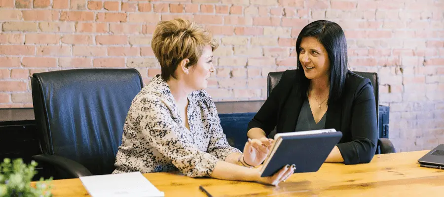 A senior professional smiling while working at a startup office