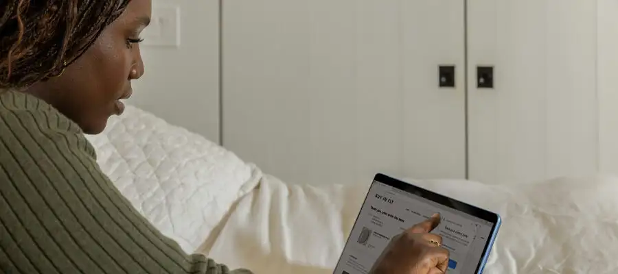 Lady looking at her business stats on a laptop