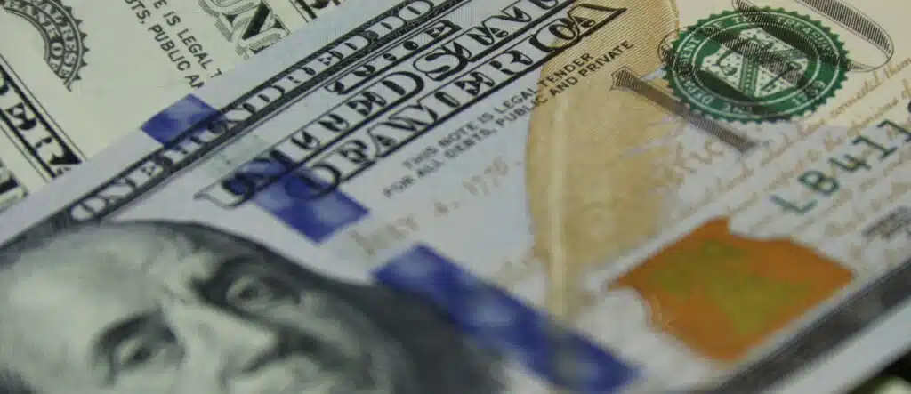 Close-up of U.S. currency, representing financial independence for senior entrepreneurs