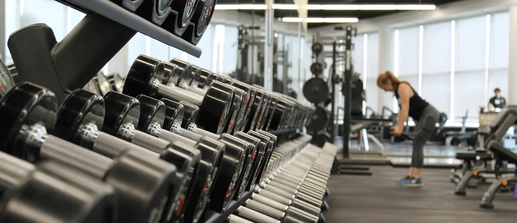 Interior view of a gym showcasing dumbbells and fitness equipment