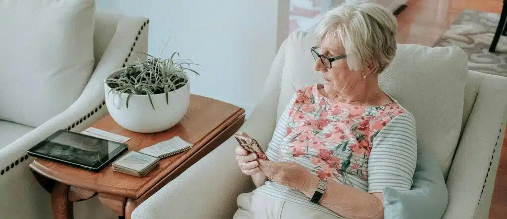 Woman sitting and using her mobile phone to manage her online startup