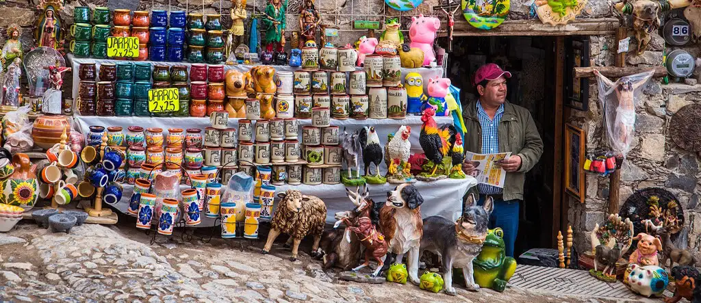 A man selling items in front of his house, showcasing a simple and personal example of micro offers in action.