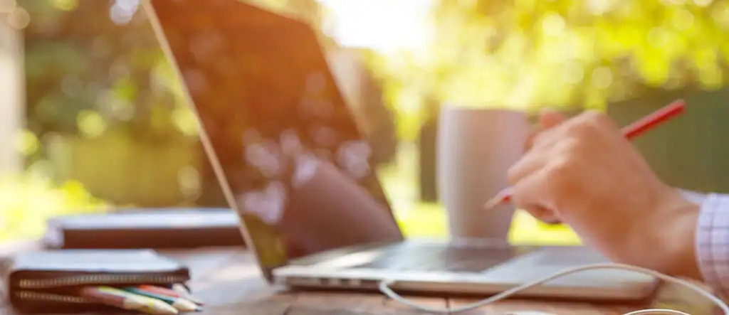 Close-up of senior hands typing on a laptop, symbolizing digital work opportunities for older adults in 2024.