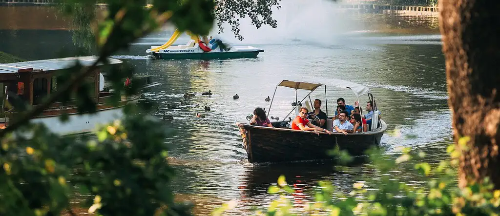 A group of people enjoying a scenic boat ride, exploring nature and sightseeing together on a calm body of water.