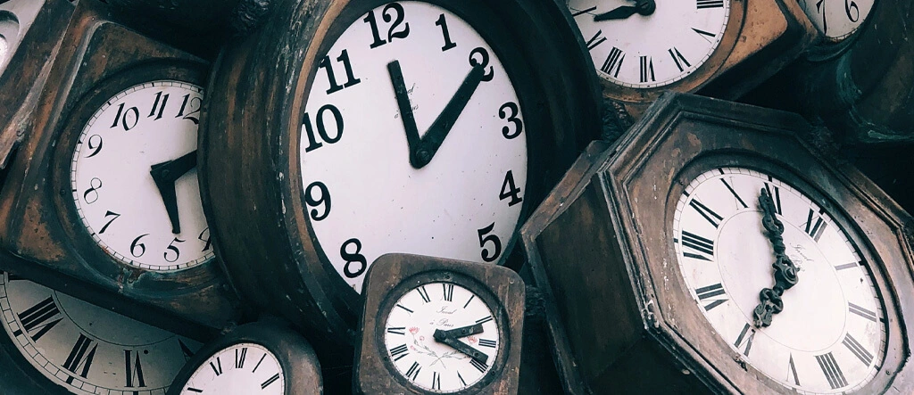 A variety of clocks symbolizing time management and the importance of establishing a routine with breaks.