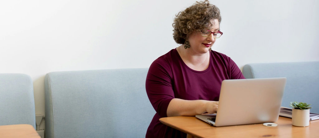 A senior woman enjoying the flexibility of freelancing on her laptop.