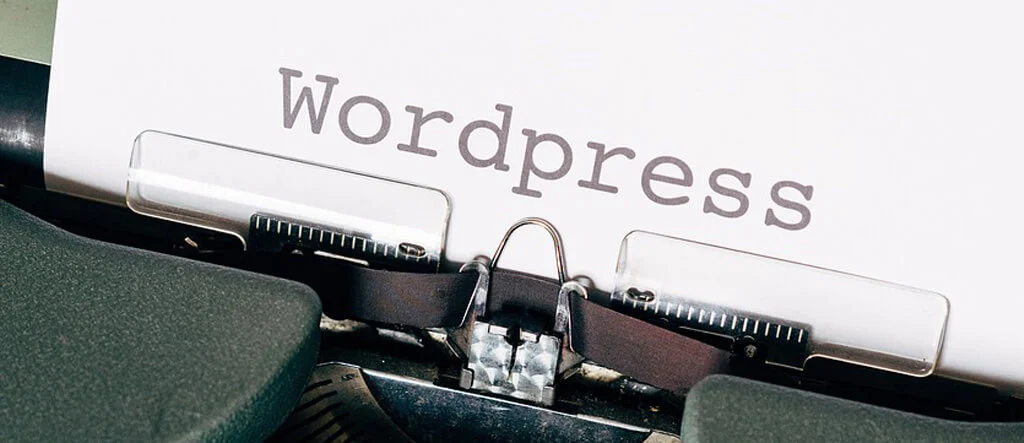 Typewriter with paper showing the word "WordPress," representing the connection between traditional writing tools and modern blogging.